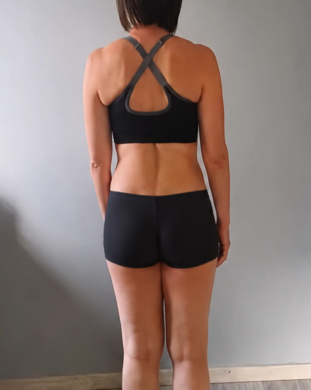 Female client after — visibly more toned and stronger a year on